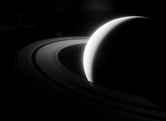 The planet Saturn in a crescent shape