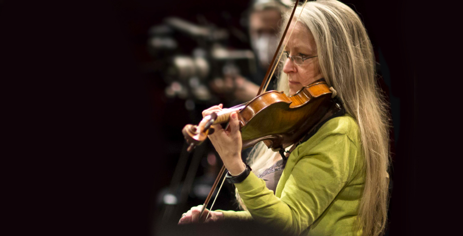 RPO Player Imogen East playing the violin in rehearsal.