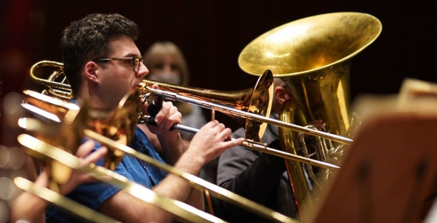 RPO Player Josh Cirtina playing the bass trombone in rehearsal.