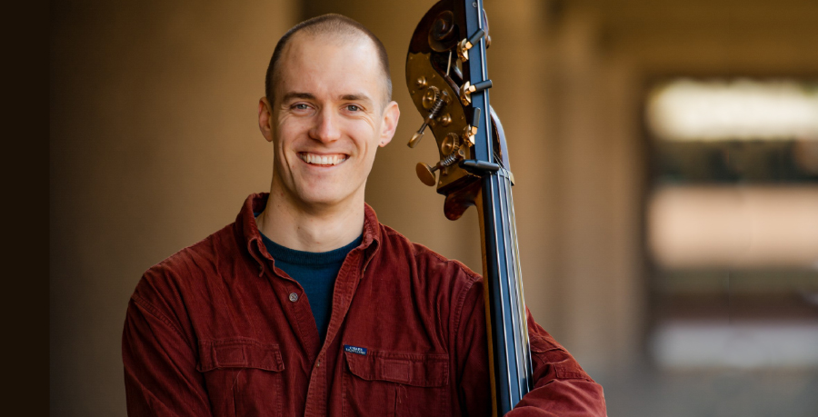 RPO Player David FC Johnson holding his double bass and smiling at the camera