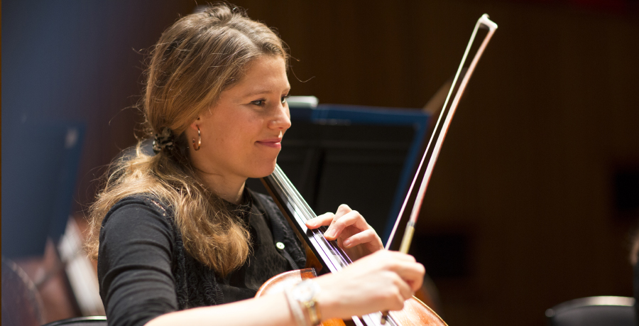 RPO player Naomi Watts smiling as she plays the cello.