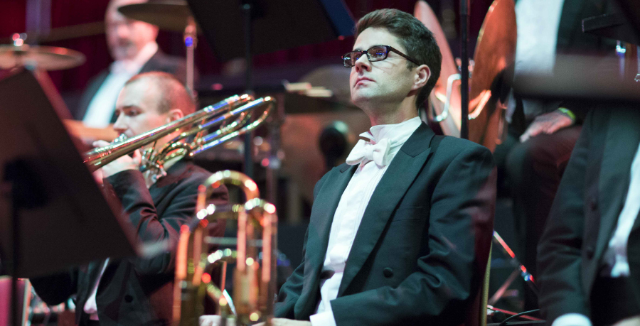 RPO Player Rupert Whitehead with his trombone in hand, seated and in concert attire.